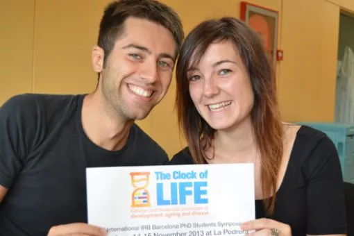 Simone Pieretti and Jessica Vitos, two of the organizers, with the poster of the 3rd IRB PhD Symposium (Photo L.T. Barone)